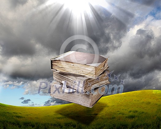 book in the air against green panoramic nature landscape book in the air against green panoramic nature landscape