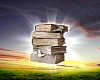 book in the air against green panoramic nature landscape