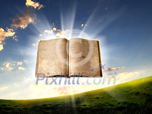 book in the air against green panoramic nature landscape book in the air against green panoramic nature landscape