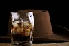 Dark drink with a hat on the background