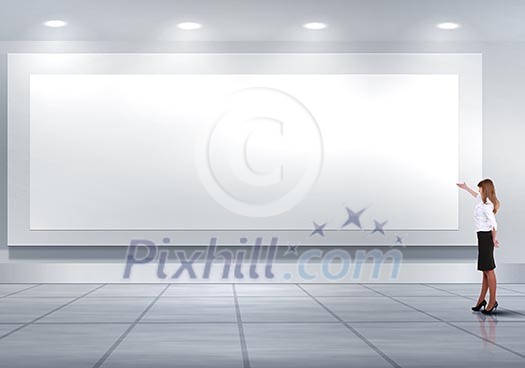 Business person standing near a blank billboard Business person standing near a blank billboard