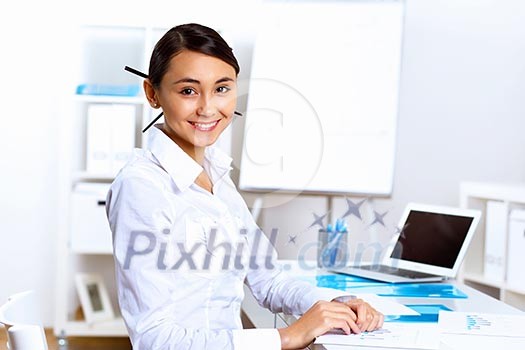 Young pretty woman in business wear working in office Young pretty woman in business wear working in office