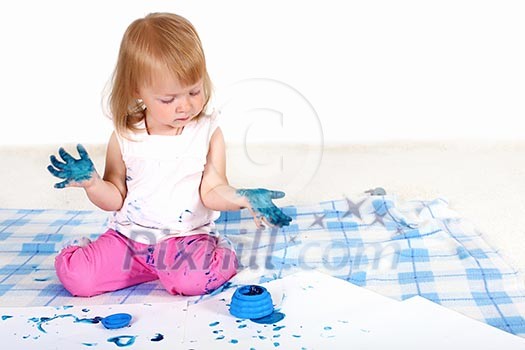 Little girl playing and painting in studio Little girl playing and painting in studio