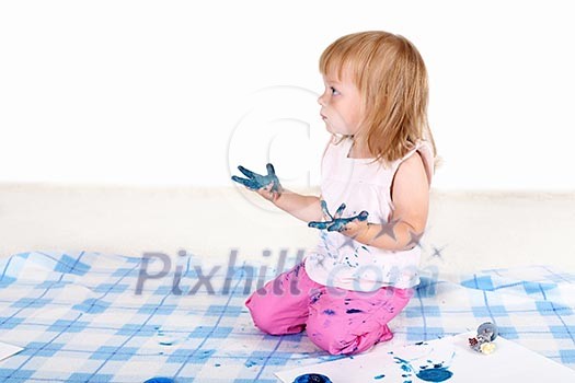 Little girl playing and painting in studio Little girl playing and painting in studio