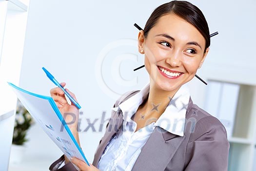 Young pretty woman in business wear working in office Young pretty woman in business wear working in office