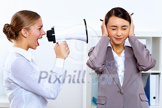 Young woman in business wear with megaphone in office Young woman in business wear with megaphone in office