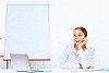 Young woman in business wear generating ideas in office