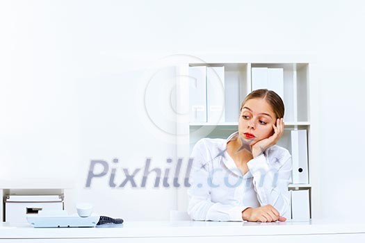 Young woman in business wear sitting with a phone in office Young woman in business wear sitting with a phone in office