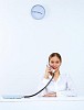 Young woman in business wear sitting with a phone in office