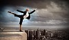 Image of pretty businesswoman balancing on the roof above cityscape