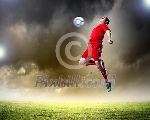 football player in red shirt striking the ball at the stadium