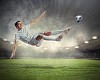 football player in white shirt striking the ball at the stadium