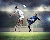 Two football players in jump to strike the ball at the stadium