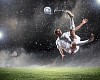 Football player in white shirt striking the ball at the stadium under rain