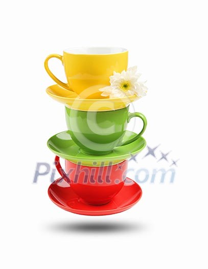 Three different colored cups facing each other on a white background Three different colored cups facing each other on a white background