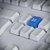 Computer keyboard with communication symbol on it