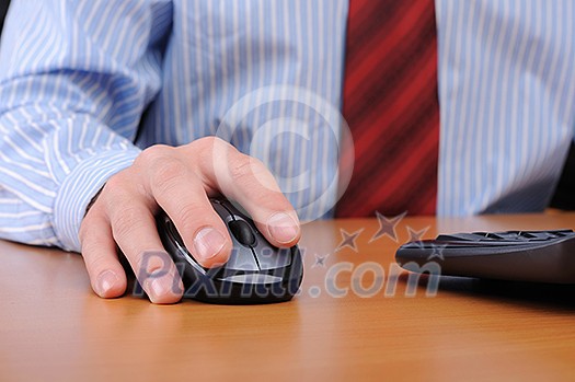 A young business man working in an office at his workplace. A young business man working in an office at his workplace.