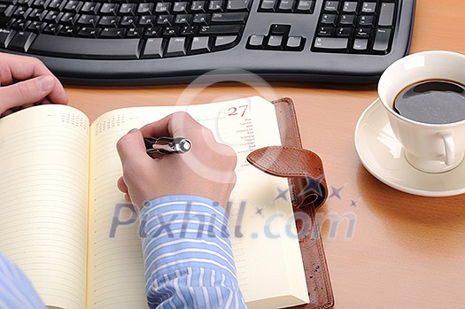 A young business man working in an office at his workplace. A young business man working in an office at his workplace.