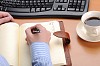 A young business man working in an office at his workplace.