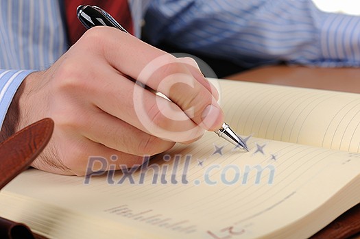 A young business man working in an office at his workplace. A young business man working in an office at his workplace.