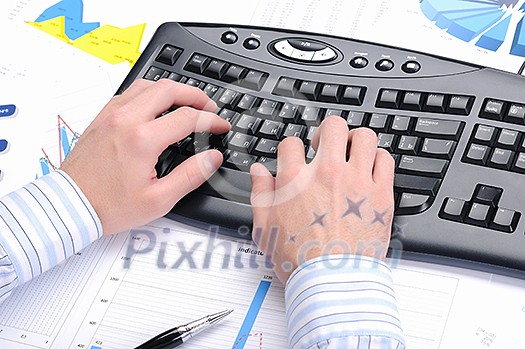 A young business man working in an office at his workplace. A young business man working in an office at his workplace.