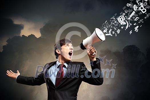 young businessman in black suit screaming into megaphone young businessman in black suit screaming into megaphone