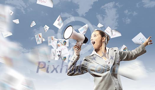 businesswoman in grey suit screaming into megaphone businesswoman in grey suit screaming into megaphone