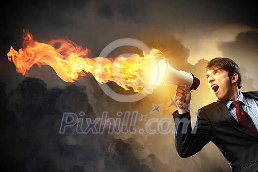 young businessman in black suit screaming into megaphone young businessman in black suit screaming into megaphone