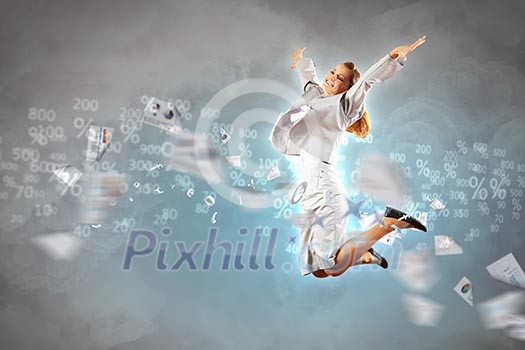 Image of a businesswoman jumping high against blue sky background Image of a businesswoman jumping high against blue sky background
