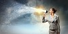 businesswoman in grey suit screaming into megaphone