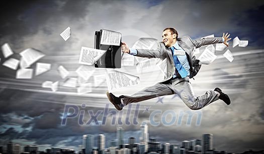 Image of a businessman jumping high against financial background Image of a businessman jumping high against financial background