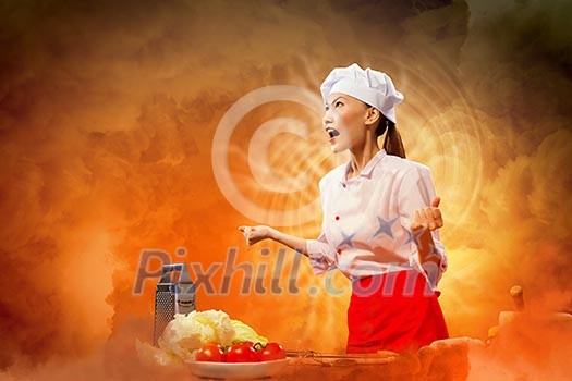 Asian female cook in anger against color background with shine effects Asian female cook in anger against color background with shine effects