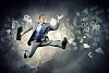Image of a businessman jumping high against financial background