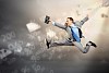 Image of a businessman jumping high against financial background