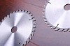 The metal disc is a circular saw on a dark background