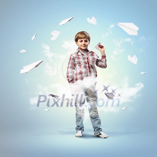 Image of little boy playing with paper airplane against blue background Image of little boy playing with paper airplane against blue background