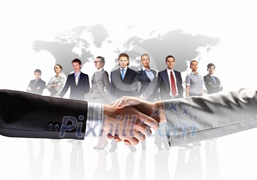business handshake against white background and standing businesspeople business handshake against white background and standing businesspeople