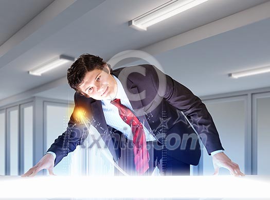 Image of young businessman looking at high-tech picture Image of young businessman looking at high-tech picture
