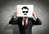 Image of businessman holding drawing against face. Conceptual photo