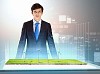 Image of young businessman looking at high-tech picture of windmills