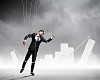 Image of businessman hanging on strings like marionette. Conceptual photography