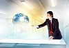 Image of young businessman clicking icon on high-tech picture of globe
