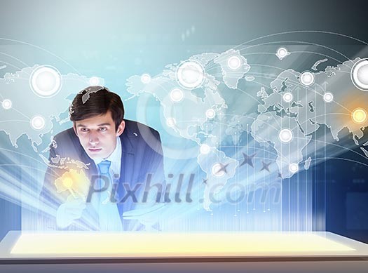 Image of young businessman clicking icon on high-tech picture Image of young businessman clicking icon on high-tech picture