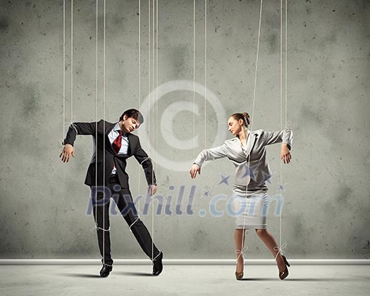 Image of businesspeople hanging on strings like marionettes. Conceptual photography Image of businesspeople hanging on strings like marionettes. Conceptual photography