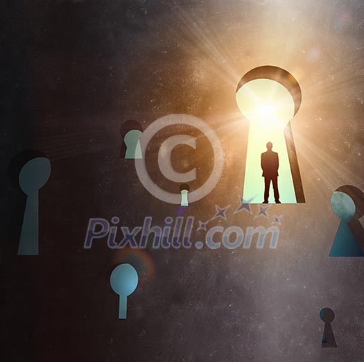 Silhouette of businessman standing in keyhole sun shining above Silhouette of businessman standing in keyhole sun shining above
