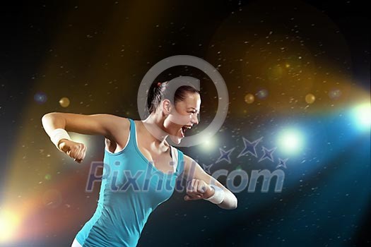 Image of sportswoman exercising against lights background Image of sportswoman exercising against lights background