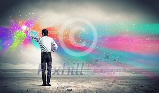 young man standing with back painting splashes with fingers young man standing with back painting splashes with fingers