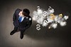 Top view of young businessman making decision currency signs in air