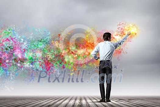 young man standing with back painting splashes with fingers young man standing with back painting splashes with fingers