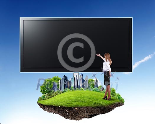 Business person standing near a blank billboard Business person standing near a blank billboard